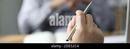 Focused photo on male hand that holding pen Stock Photo