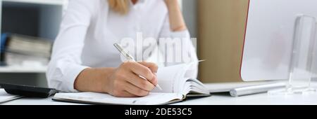 Focused photo on female hand that making notes Stock Photo