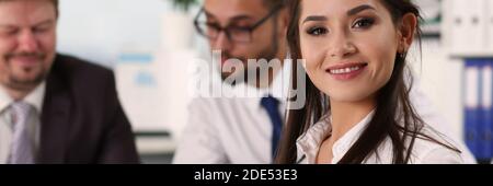 Positive delighted young woman looking at camera Stock Photo