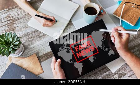 Fake news sign on screen. Propaganda and disinformation. Media and internet concept Stock Photo