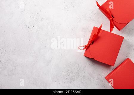 Red Christmas gift boxes on white textured background Stock Photo