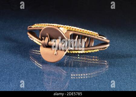 The Hair clip. The Pin for hair on turn blue the table with reflection. Personal subjects on black background Stock Photo