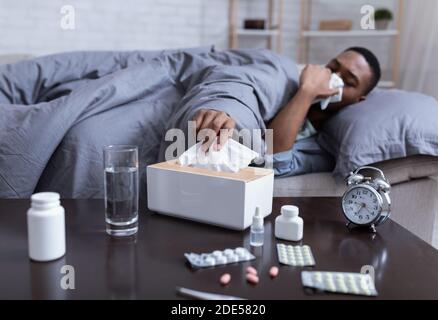 Ill African American Man Sneezing Having Sinusitis At Home Stock Photo