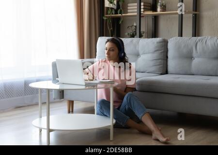 Focused millennial indian arab woman watching webinar online. Stock Photo