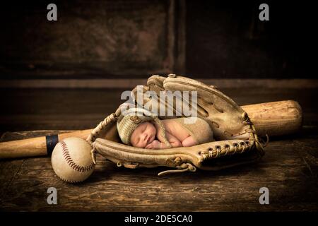 Newborn baby sleeping in an old leather baseball glove Stock Photo Alamy