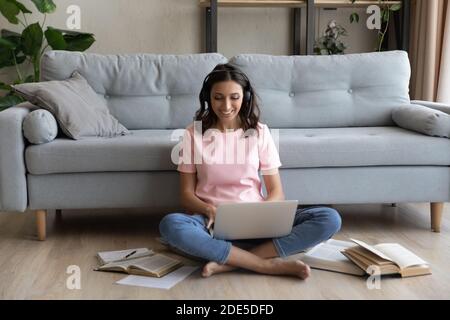 Happy beautiful millennial mixed race woman studying online. Stock Photo