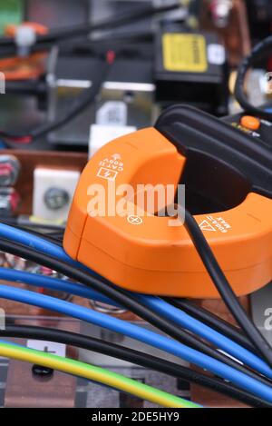 Clamp meter measure current on cable on power supply devices Stock Photo