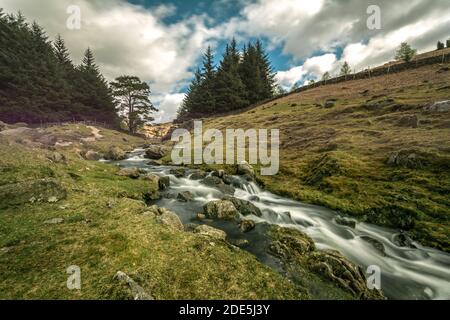 Bleamoss beck is a picturesque stream that flows out of blea tarn and cascades past tarnclose crag in the english lake district cumbria Stock Photo