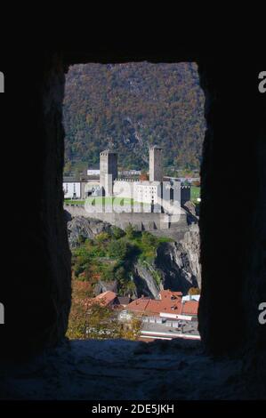 View of the Castelgrande Castle of Bellinzona through a window frame of Montebello castle. The Castelgrande castle is part of the Unesco World heritag Stock Photo