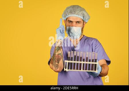Epidemic threshold. Man in medical lab inspecting samples biological material. Epidemic disease. Virus concept. Epidemic infection. Genetic analysis. Critical number or density of susceptible hosts. Stock Photo