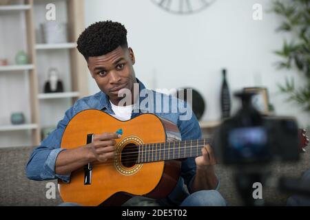 young guitar player recording video for his blog Stock Photo