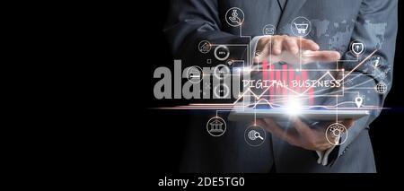 Digital online business. Businessman analyzing the sales market with virtual graphics holding a tablet. Business, marketing and internet concept Stock Photo