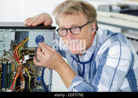 mature engineer repairs computers hard drive Stock Photo