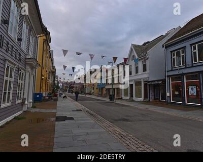 Tromsø, Norway - 08-23-2020: Shopping street and pedestrian zone Storgata in the old center of Tromsø with shops and restaurants on cloudy day. Stock Photo