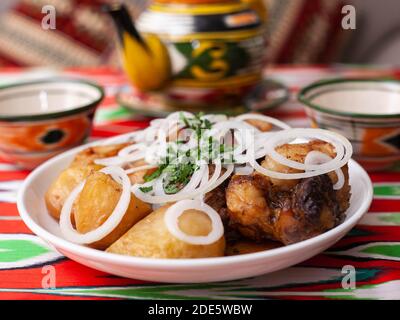 An oriental dish of grilled beef, potatoes and onions with herbs. Asian style Stock Photo