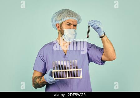 Epidemic disease. Virus concept. Epidemic infection. Genetic analysis. Critical number or density of susceptible hosts. Epidemic threshold. Man in medical lab inspecting samples biological material. Stock Photo