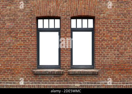 Beautiful old rough brick wall and windows with black frame and isolated white empty space. Stock Photo