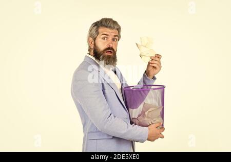 Recover document. Insure important documents. Recover files after deletion. Businessman hold trash can. Destroy evidence. Man look for lost document in paper bin. Office worker digging in garbage bin. Stock Photo