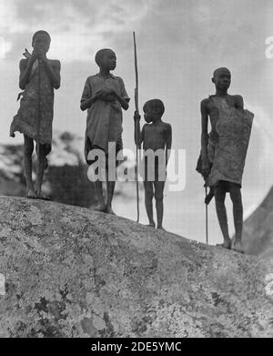 Middle East History - Uganda. From Hoima to Fort Portal. Four shepherd boys against an evening sky Stock Photo