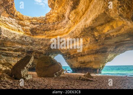 Benagil sea cave, from inside, with 2 visitors, Algarve, Portugal, popular destination tourism Stock Photo
