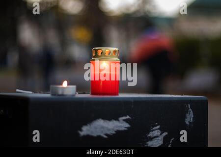 Two lit candles on trashcan on Slovak anti governmental demonstration against corona virus restrictions Stock Photo