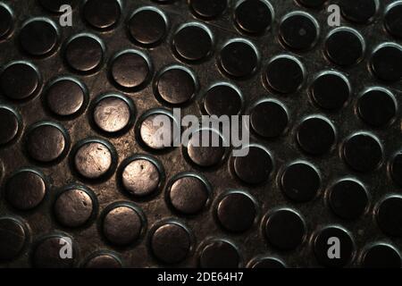 Black  rubber floor with dots, non-slip matting in industrial setting Stock Photo