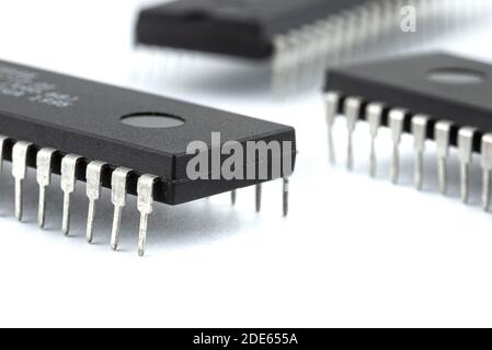 A macro shot of a DIP 40 pin computer microchip, isolated on a white background. Stock Photo