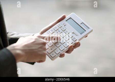 Close up of businessman using calculator Stock Photo