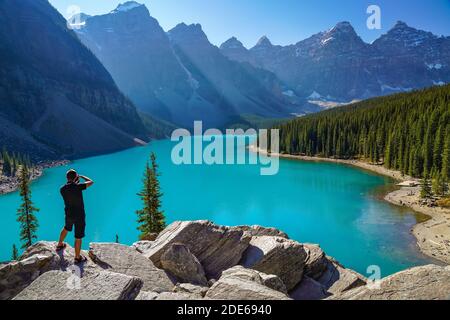 Moraine Lake Rockpile Trail in summer sunny day morning, Tourists taking pictures on the beautiful scenery. Banff National Park, Canadian Rockies Stock Photo
