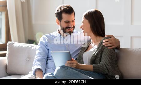 Happy young couple relax using tablet at home Stock Photo
