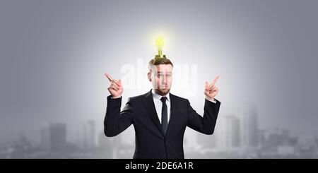 Caucasian white businessman on a gray background shows that he has ideas Stock Photo