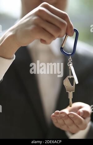 Businessman holding key ring and key Stock Photo