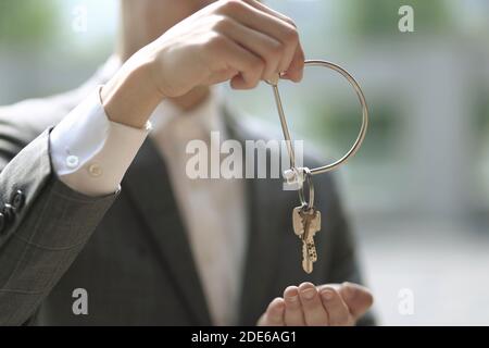 Businessman holding key ring and key Stock Photo