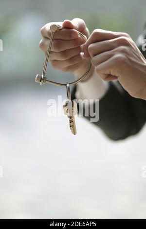 Businessman holding key ring and key Stock Photo