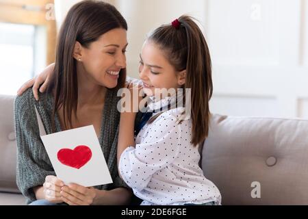 Caring daughter greeting excited mom with birthday Stock Photo