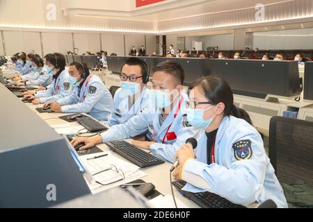 (201129) -- BEIJING, Nov. 29, 2020 (Xinhua) -- Technical personnel work at the Beijing Aerospace Control Center (BACC) in Beijing, capital of China, Nov. 29, 2020. China's Chang'e-5 probe performed braking for the second time at 20:23 p.m. Sunday (Beijing Time), according to the China National Space Administration (CNSA). After the deceleration, the probe started flying in a near circular orbit from an elliptical path around the moon, said the CNSA. (BACC/Handout via Xinhua) Stock Photo