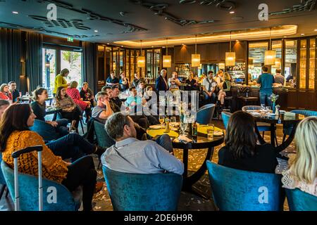 Bar of The Dunloe Hotel near Killarney, Ireland. The bar offers an inviting, cozy atmosphere. It is also well frequented during the day, as here on the occasion of the Rugby World Cup in Japan at the match of the Irish national teamtelevised Rugby Game Stock Photo