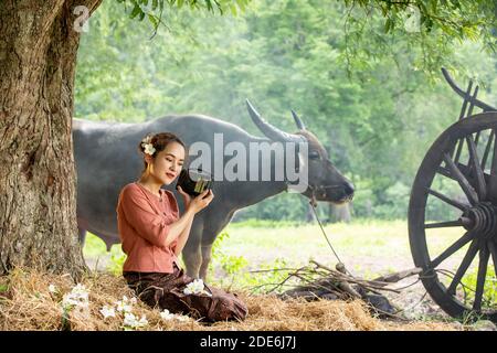 Thailand's farmer in rural scene with buffalo Stock Photo