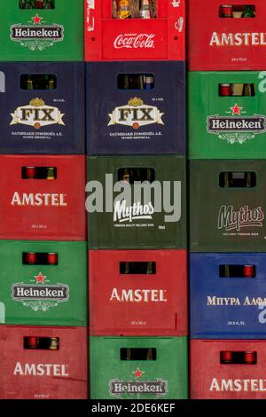 A pile or stack of brightly coloured plastic beer or ale lager crates ready for collection on the empties. Stock Photo