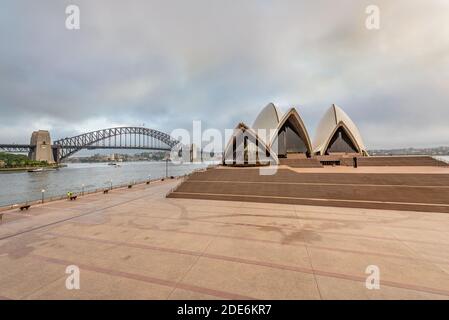 Sydney, Australia - Early morning at the Sydney Opera House. The Harbour Bridge can be seen in the background. Stock Photo