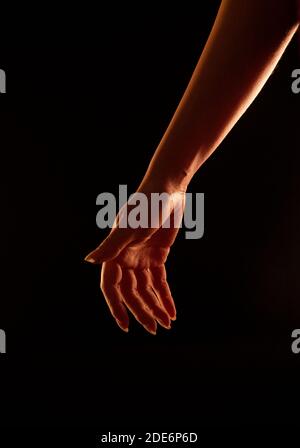 Beautiful Woman's Hand in Rim Light  - Relaxed Stock Photo