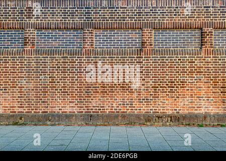 Brickwall background with sidewalk Stock Photo