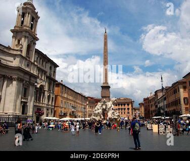 A busy market in the Piazza Navona in Rome, Italy behind which, in the centre, stands the famous Fountain of the Four Rivers Stock Photo