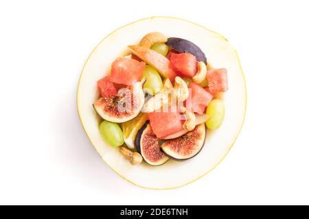 Vegetarian fruit salad of watermelon, grapes, figs, pear, orange, cashew isolated on white background. Top view, flat lay, close up. Stock Photo