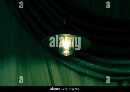 Lamps with vintage incandescent bulbs in green light