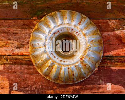 Aluminum bakeware for baking in the oven. Aluminum baking dish made of flour dough. Wooden kitchen table. Home kitchen. Bakers tool. Cook equipment. C Stock Photo