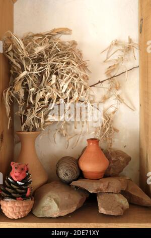 View of pot on stones in wooden shelf Stock Photo
