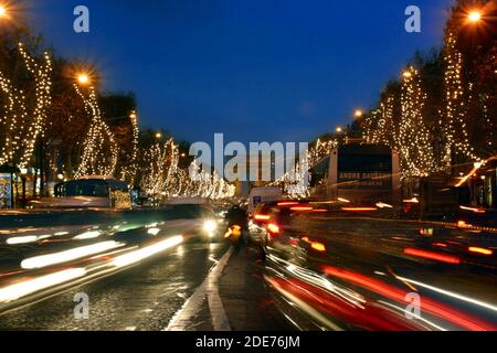 Champs Elysee in Christmas decorations with a view of the Arc de Triomphe at blue hour Stock Photo
