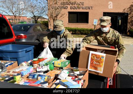 U.S. Air Force airmen load donated food items collected by their unit for distribution by the Columbia Food Bank at McEntire Joint National Guard Base November 20, 2020 in Columbia, South Carolina. The pandemic has caused an increase in food insecurity with long lines at food banks across the country. Stock Photo