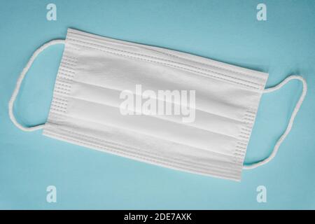 Protective face mask isolated on blue background. Coronavirus concept and background. Stock Photo